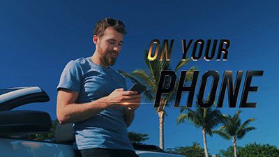 Screenshot from a product marketing video of a man on his phone. 